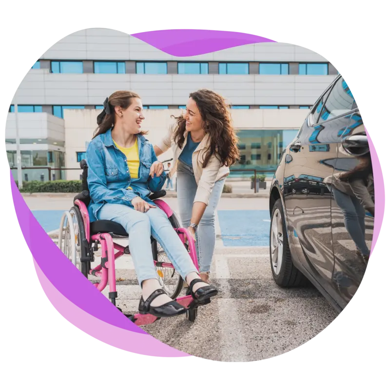 Female participant being helped into a car by her female support worker